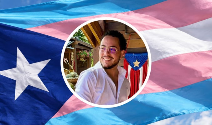 David's headshot in front of a trans pride Puerto Rican flag