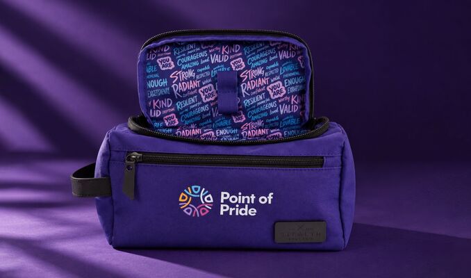 Stealth Bros x Point of Pride purple dopp kit in front of a purple backdrop