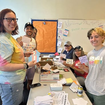 Staff and volunteers volunteer to package binders