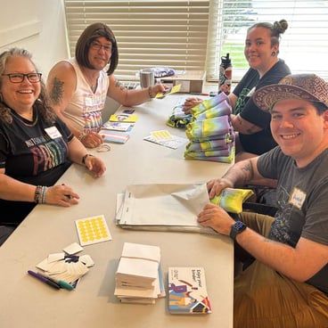 Staff and volunteers volunteer to package binders