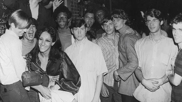 Queer people smiling together after Stonewall