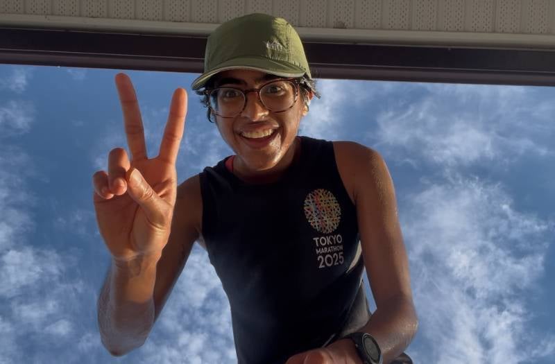 Athlete smiles and gives a peace sign to the camera