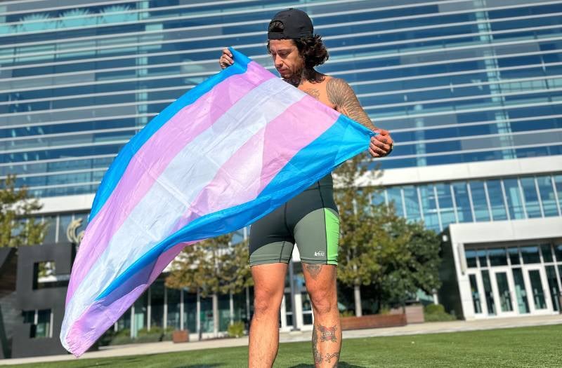 Athlete holding trans flag