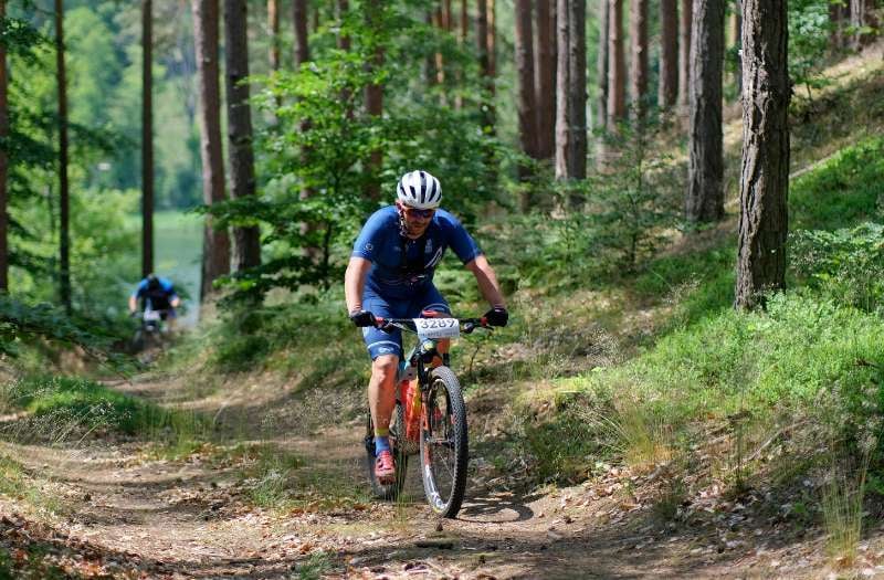 Cyclist on dirt path in woods