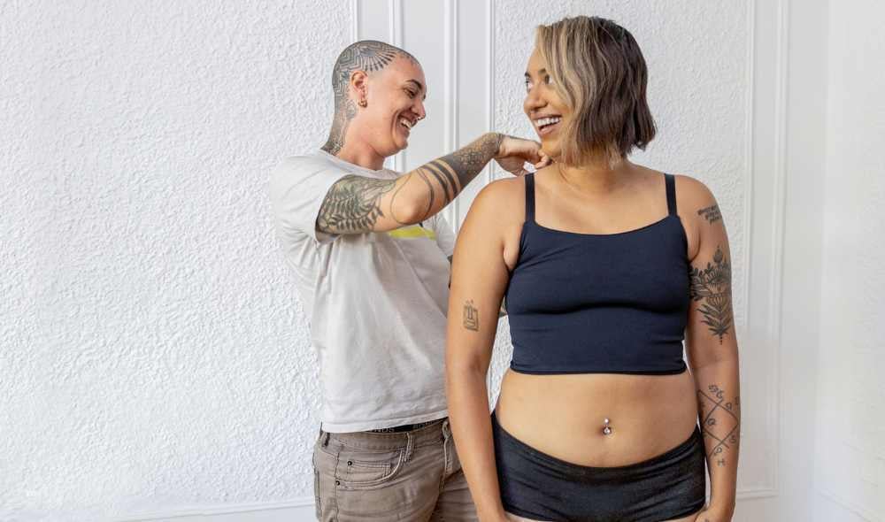 Rae helps adjust a garment on a model