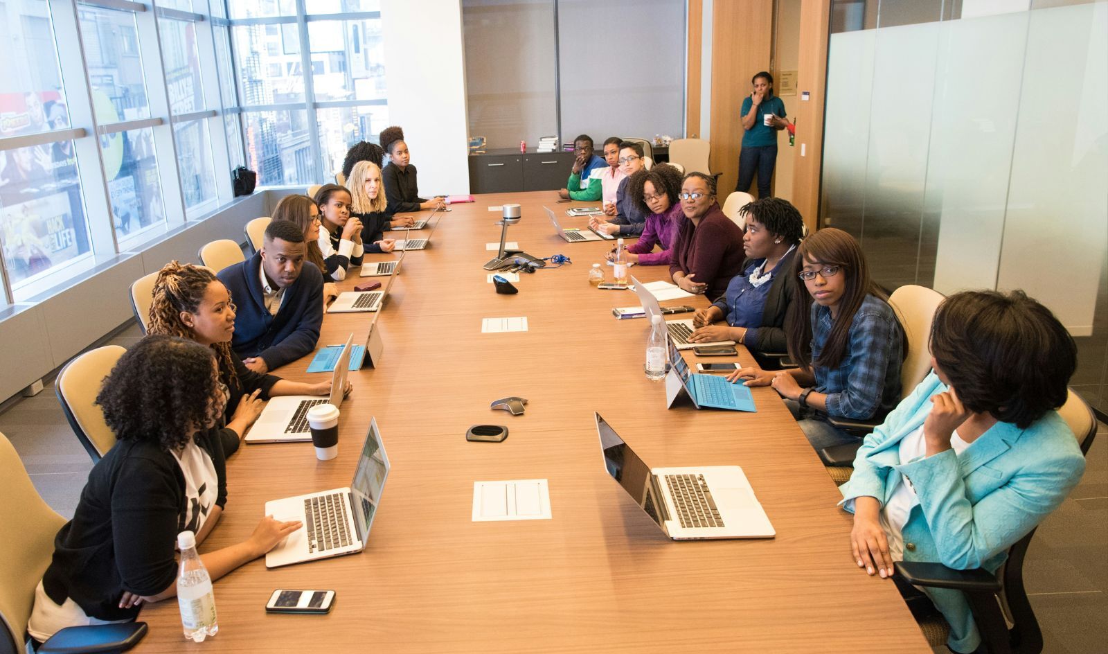 Employees gathered around a conference table
