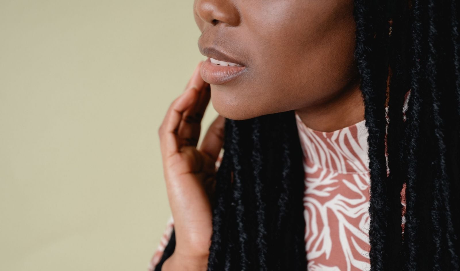 Portrait of a woman touching her face