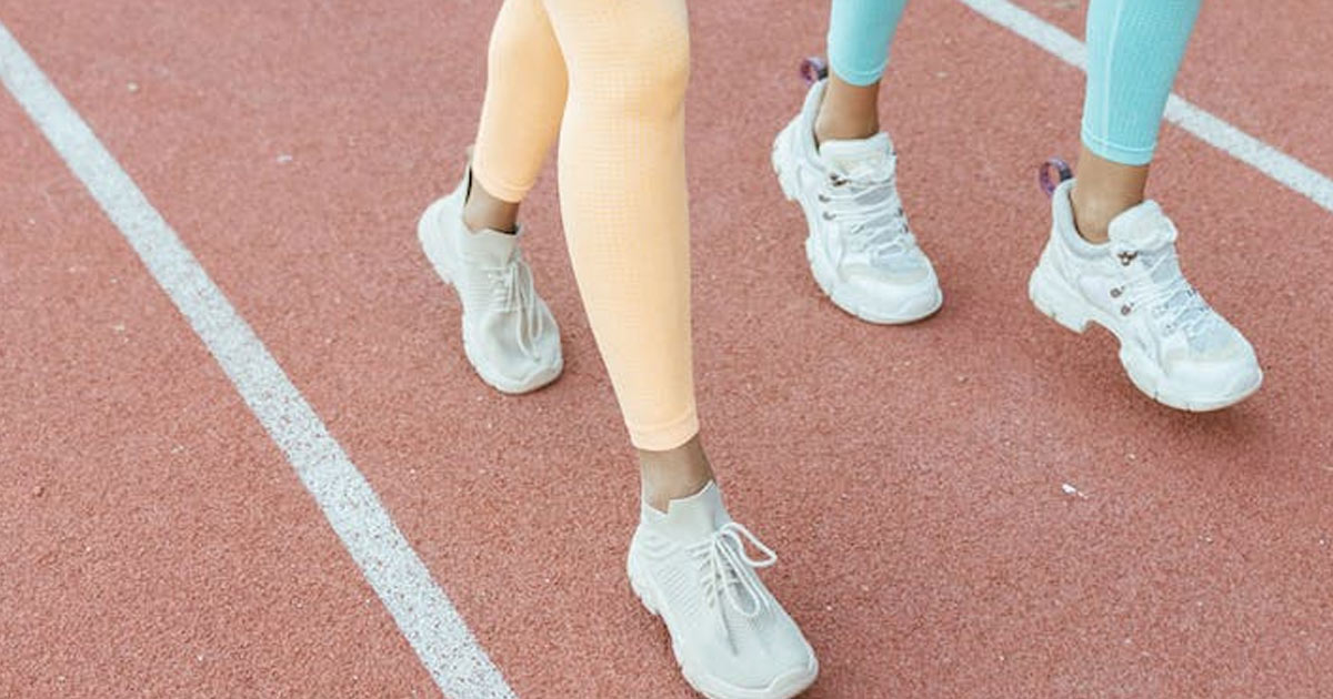 Close-up of sneakers walking on track
