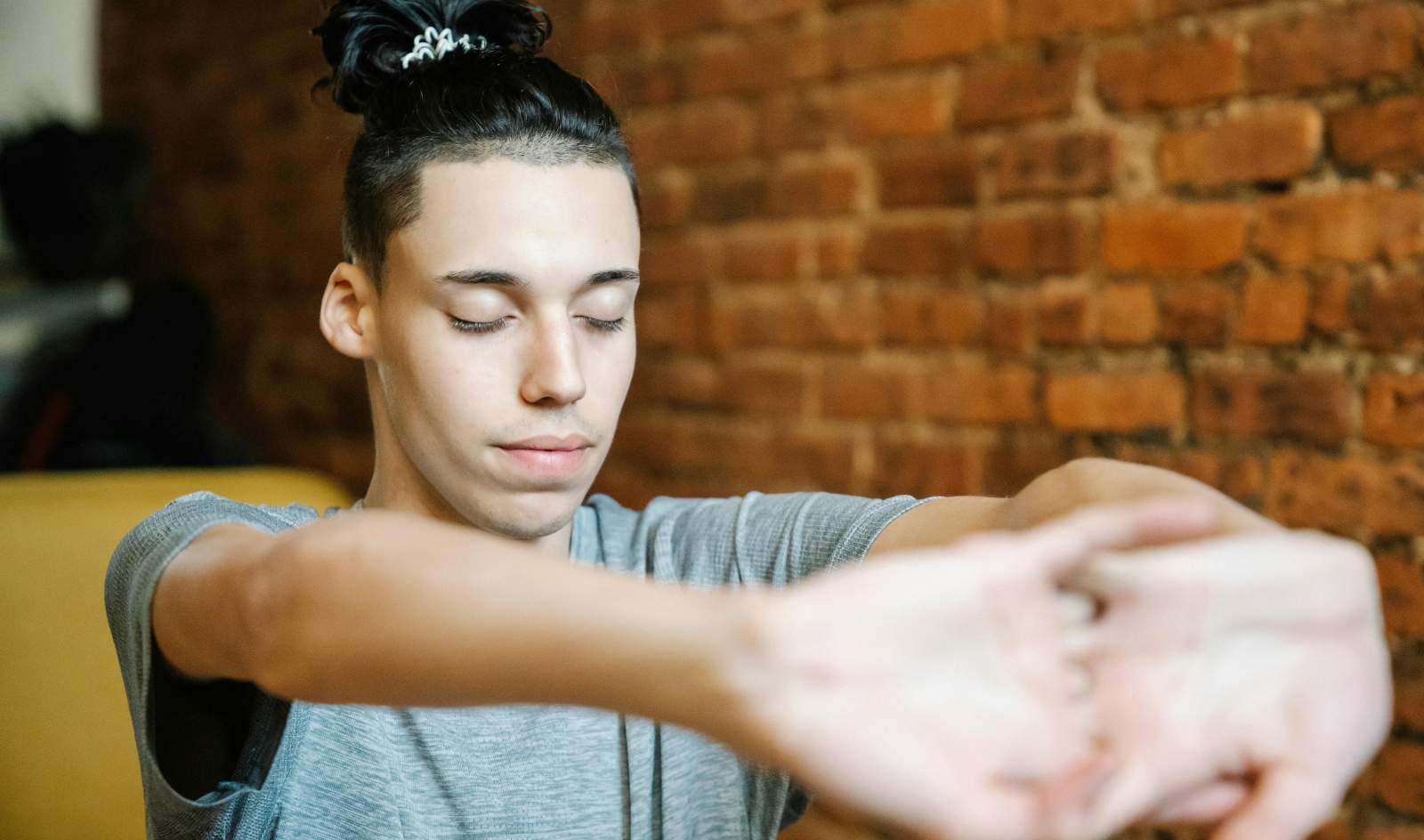 Person stretches hands out with eyes closed