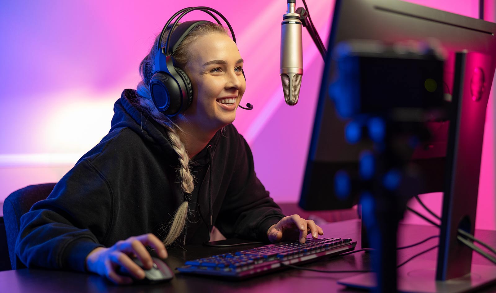 Smiling femme gamer at computer