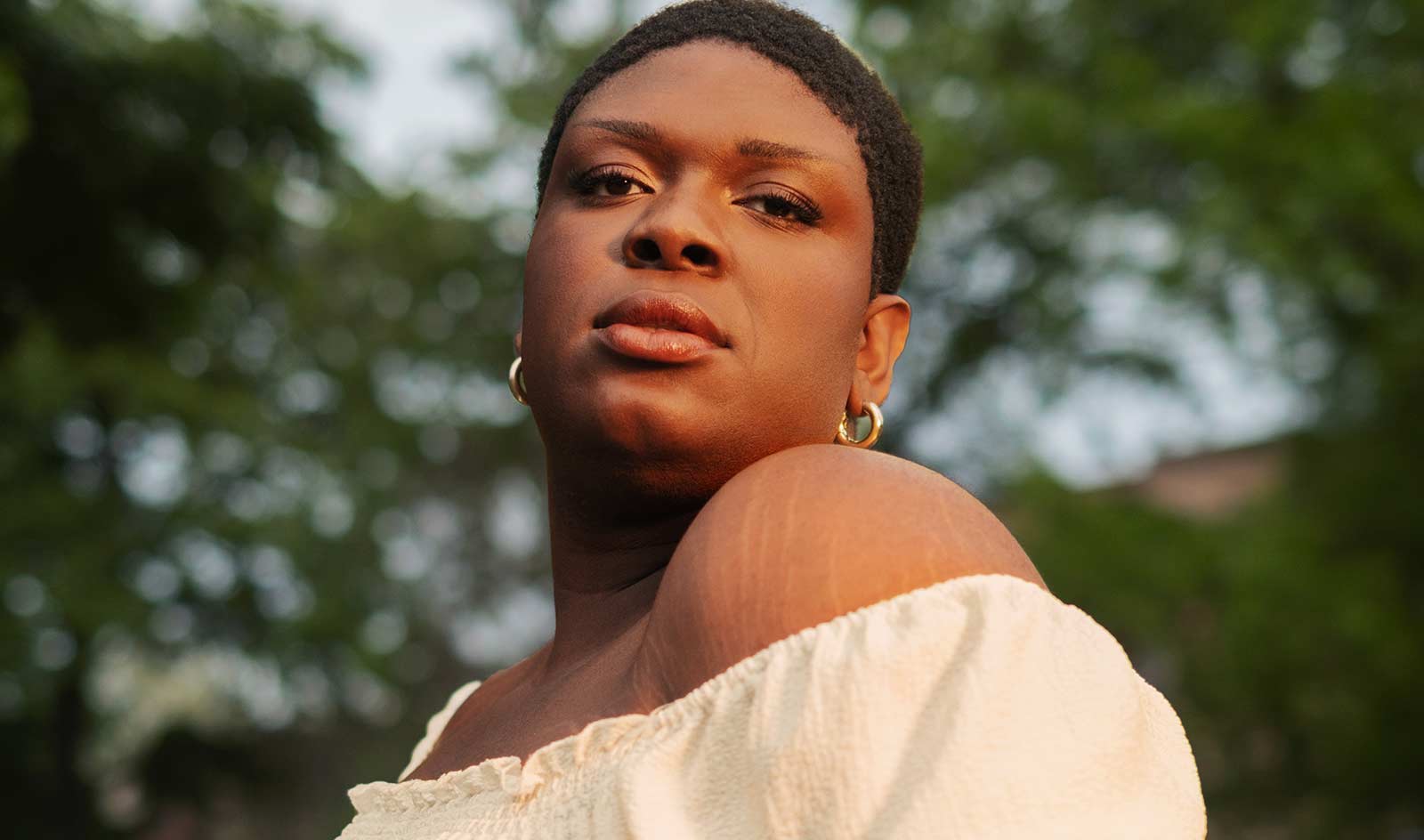 Close-up portrait of an agender person outside