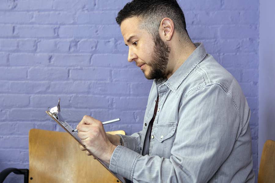 Person completing insurance form in doctor's office